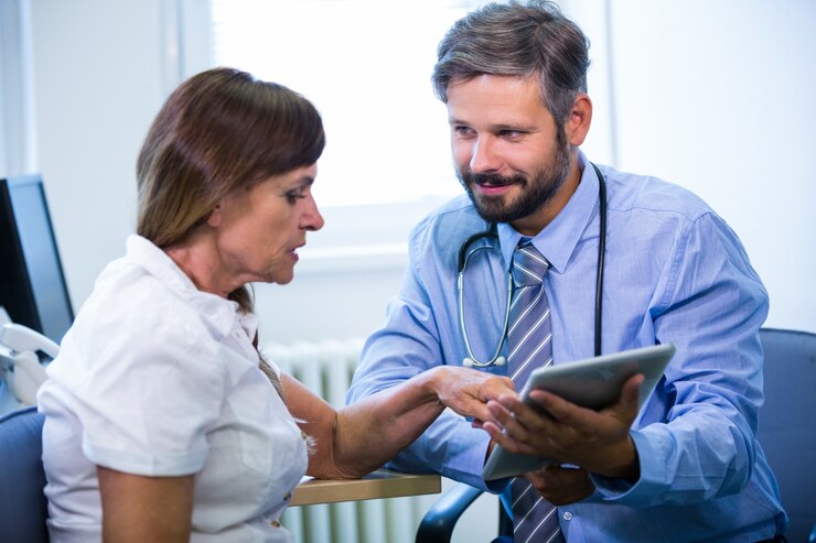 A health professional discussing a care needs assessment with an elderly lady. A health professional discussing a care needs assessment with an elderly lady.