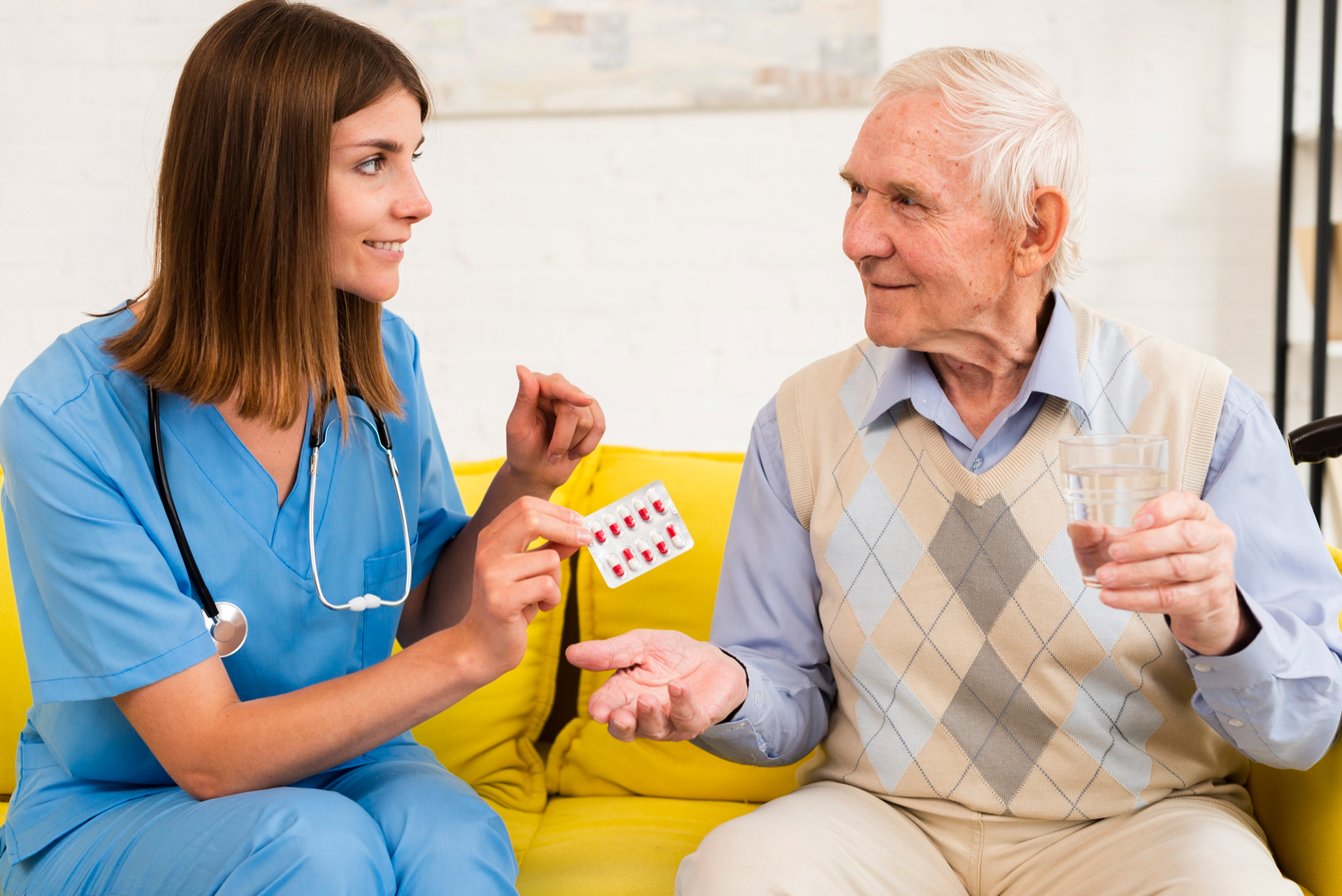 An elderly man discussing his medication with his home carer. An elderly man discussing his medication with his home carer.