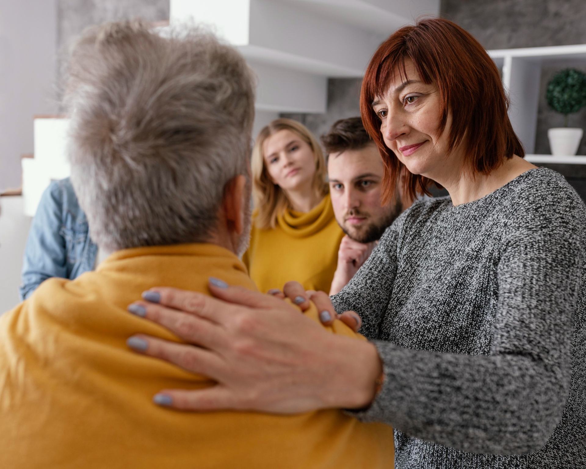 A family reassuring their elderly relative. A family reassuring their elderly relative.