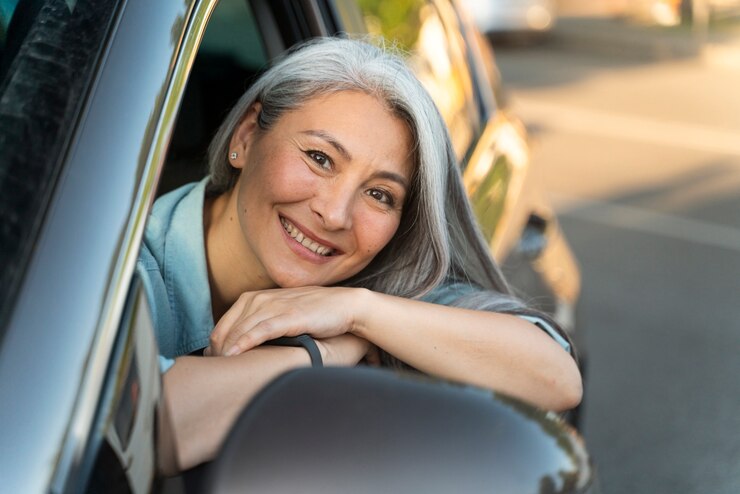 A home care agency worker leaning out of her car window and smiling as she benefits from Fair Mileage Reimbursement. A home care agency worker leaning out of her car window and smiling as she benefits from Fair Mileage Reimbursement.